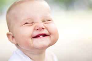 Smiling baby showing teeth