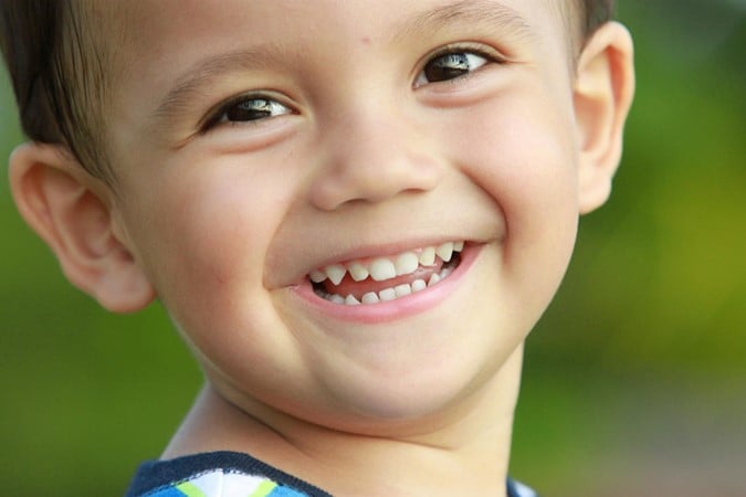 A young boy smiling.